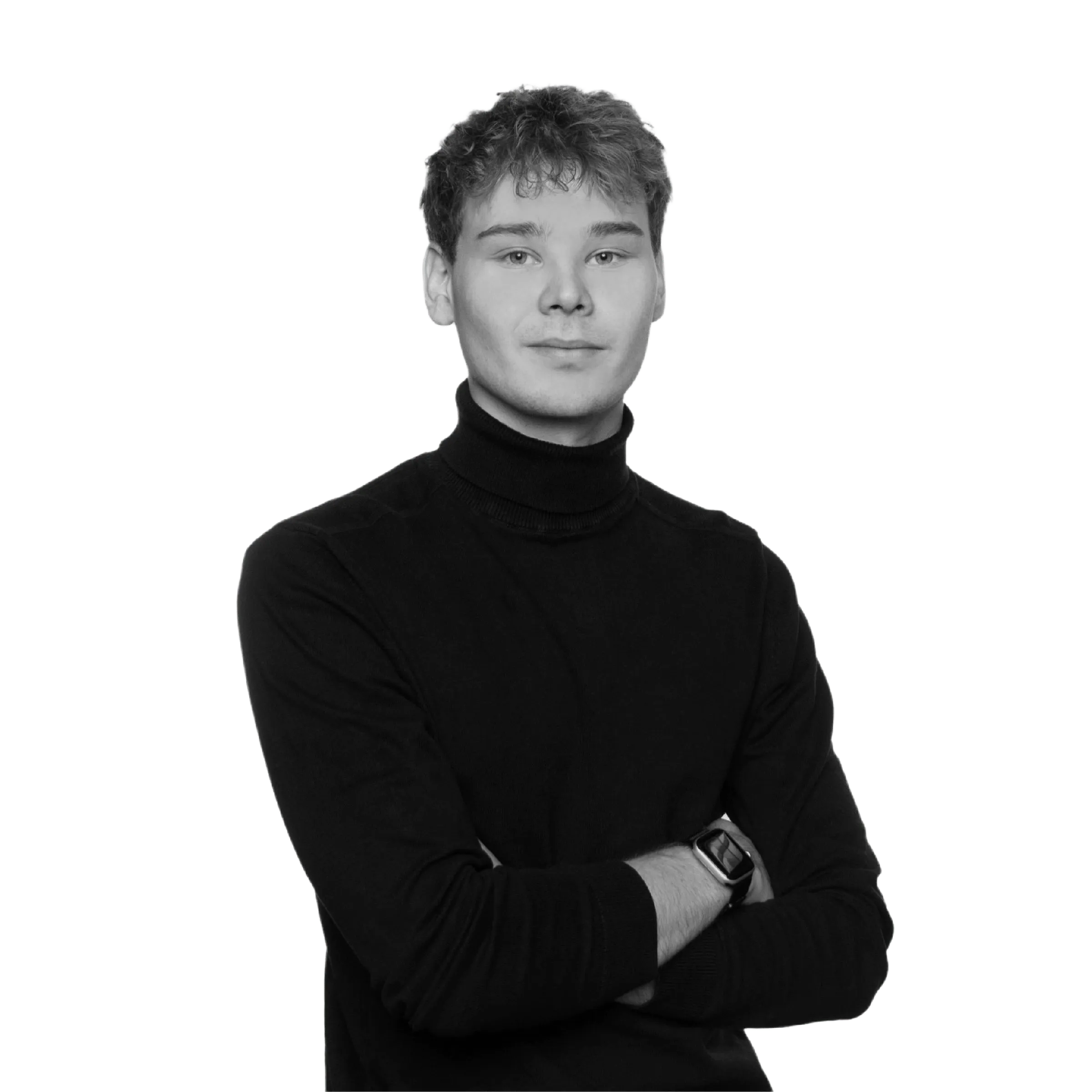 Young man with curly hair wearing a black turtleneck sweater and smartwatch, arms crossed.